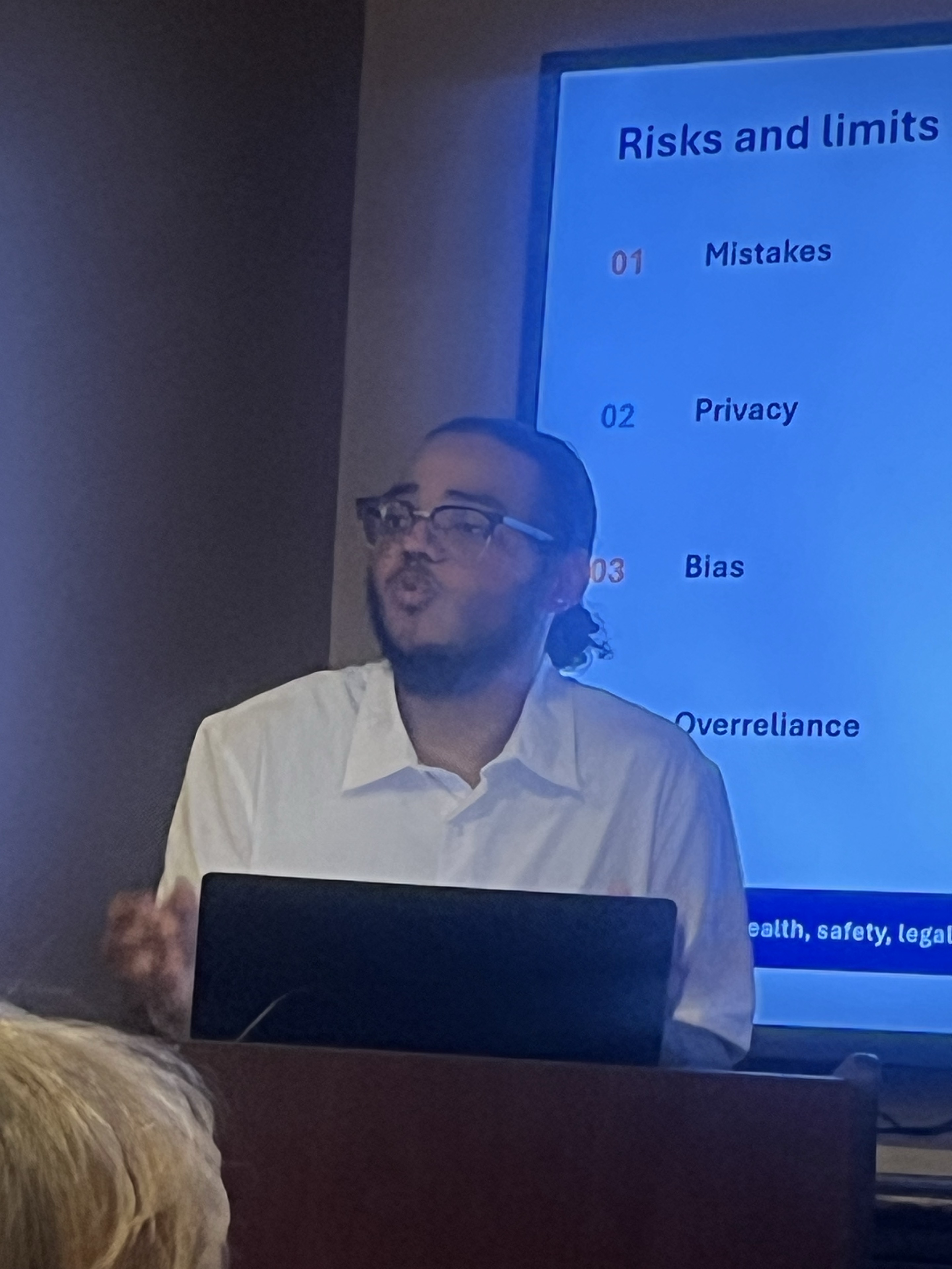 William presenting a slide about AI risks and limitations